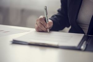 An attorney writing a MSPB appeal at a desk